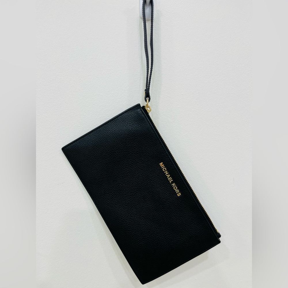 Calvin Klein wristlet wallet. Black with yellow gold hardware.